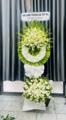 Elegant floral tribute arrangement in white
